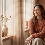 start Frau informiert sich ueber Hormonersatztherapie in den Wechseljahren am Fenster